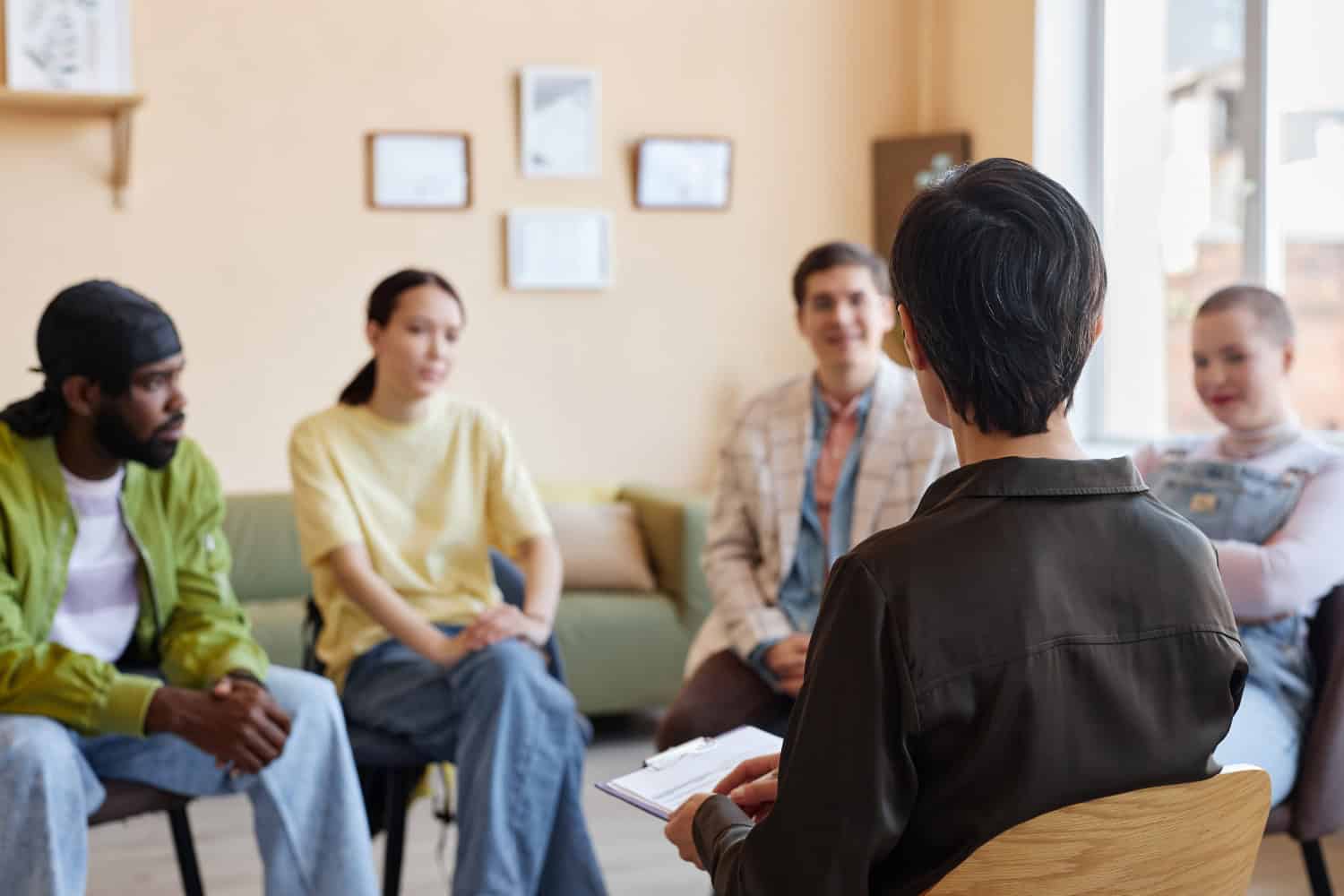 Psychologist talking to people in office