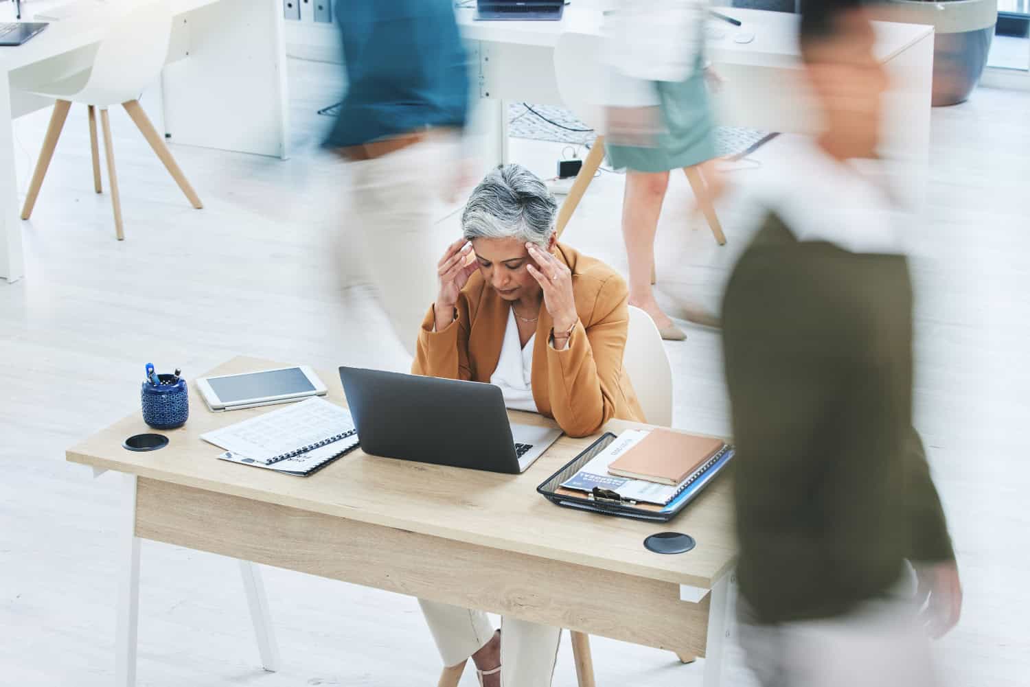 senior woman with headache, crisis or vertigo while working on a laptop