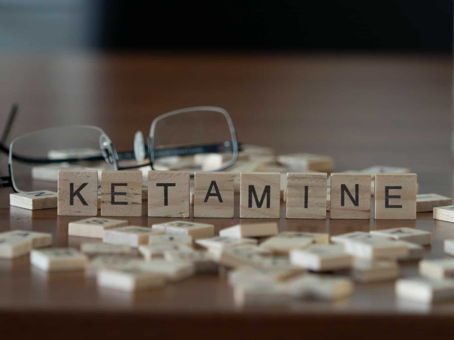 Ketamine Addiction, ketamine concept represented by wooden letter tiles on a wooden table