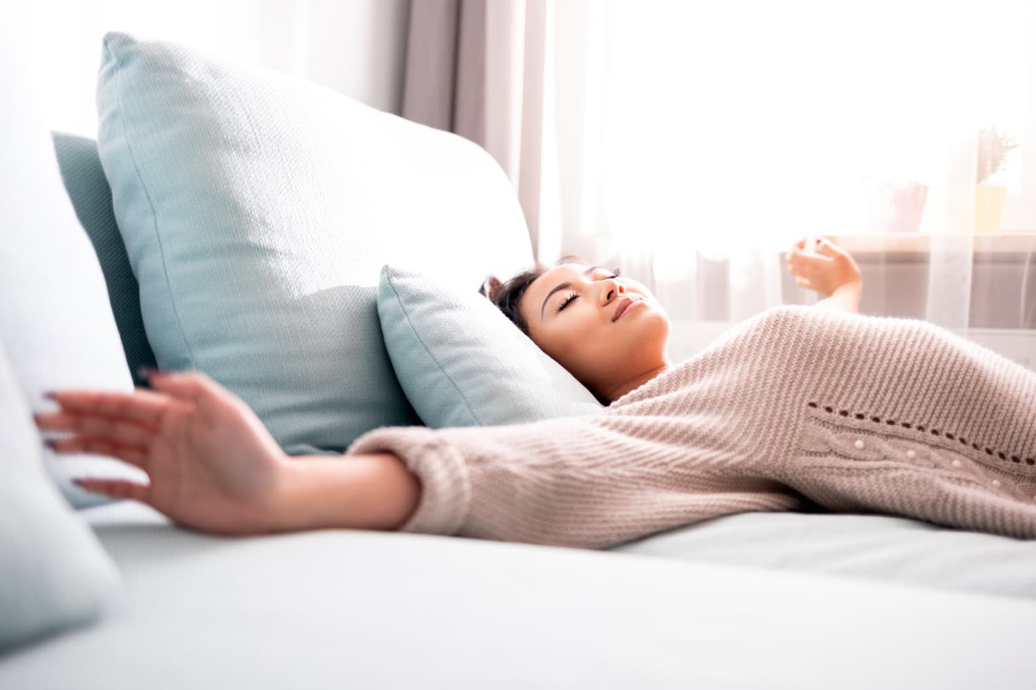 young woman waking up from relaxing sleep, importance of sleep in recovery