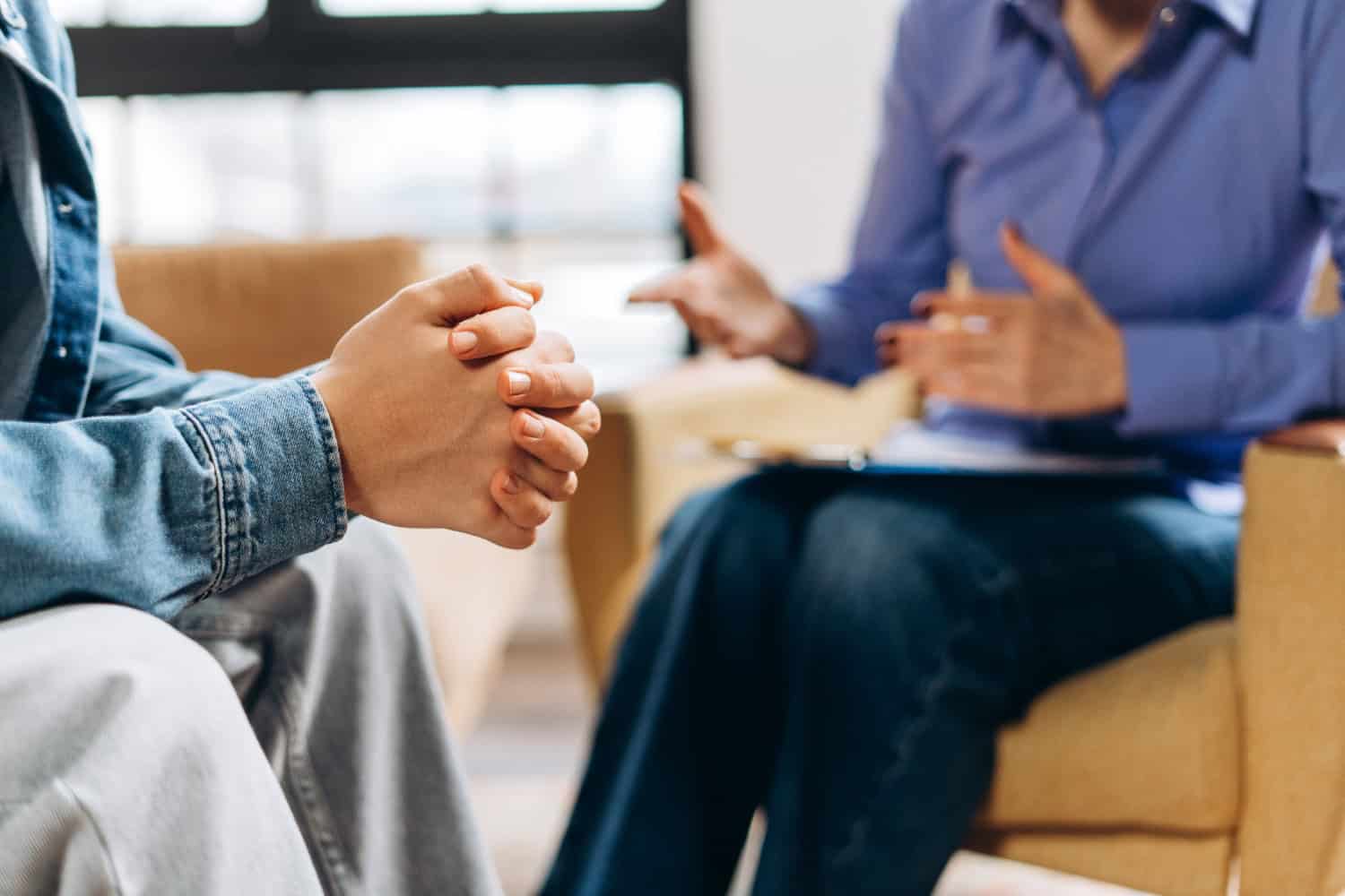 Psychologist discussing mental health with patient client sitting in psychotherapist office