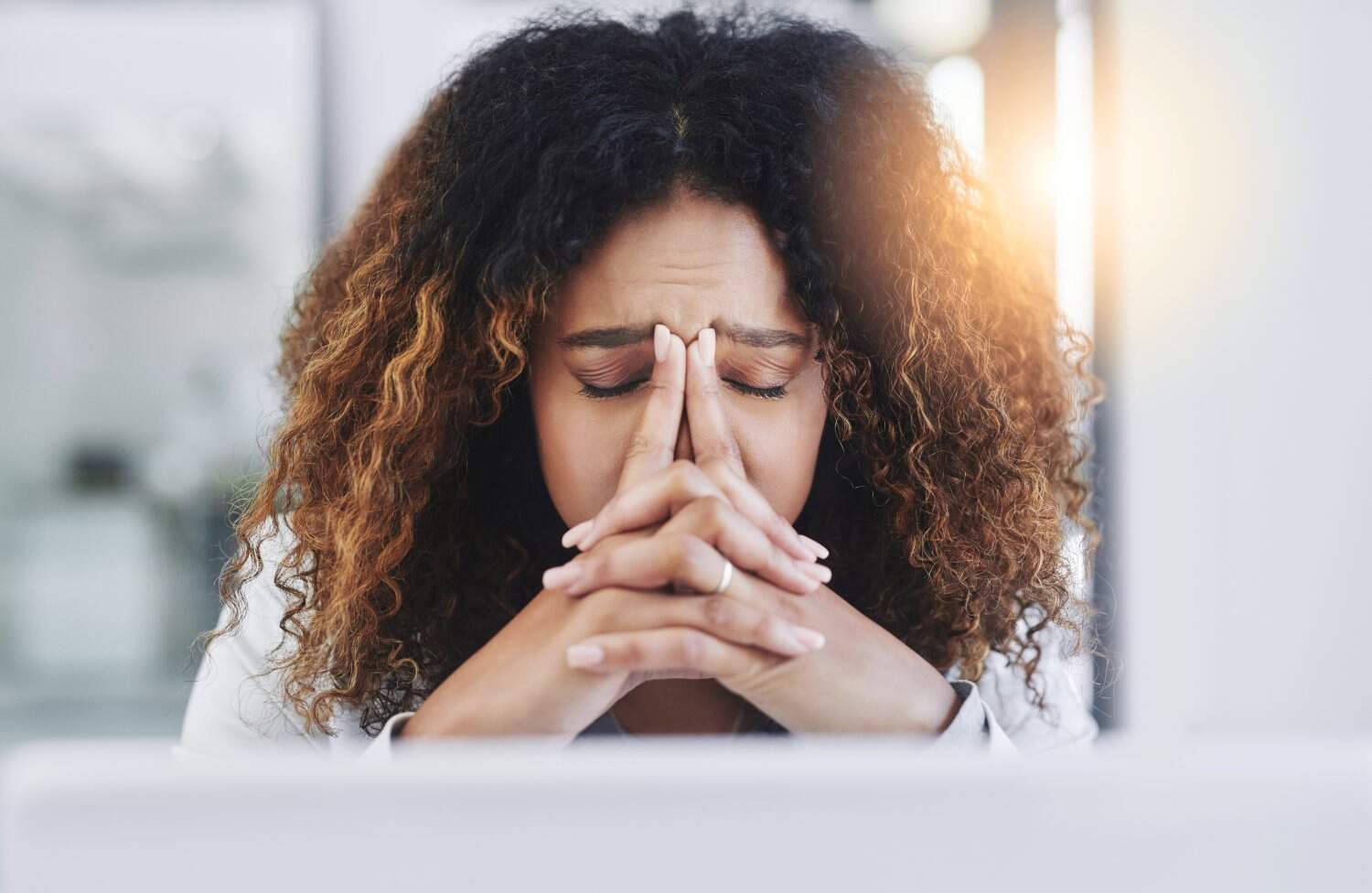 young businesswoman looking stressed and tired at work, concept of chronic stress