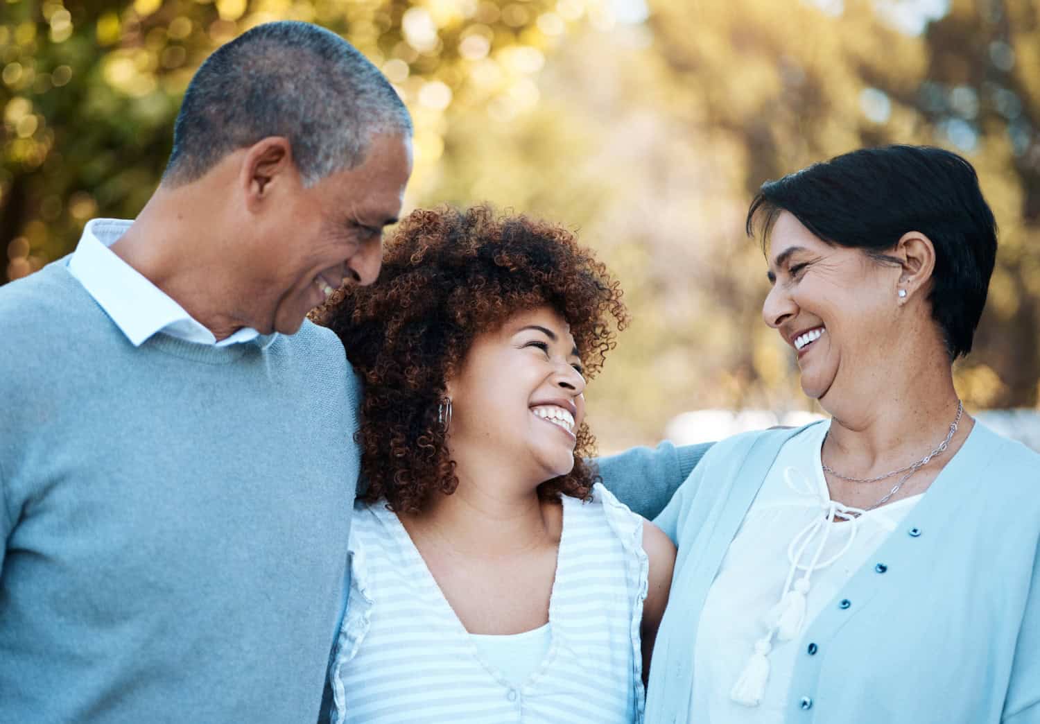 smiling family are enjoying a bright day outdoors