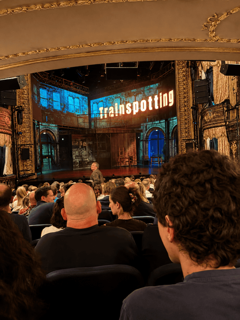 Theater audience viewing Trainspotting performance